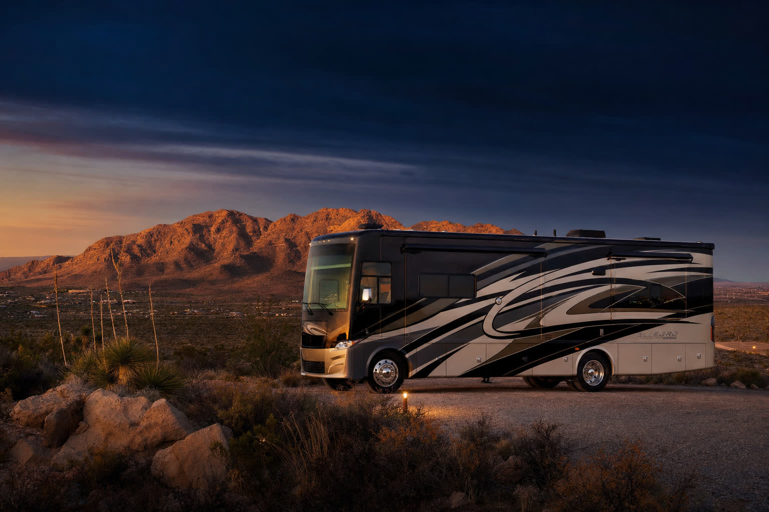 Class A motorhome parked near the Franklin Mountains at dusk