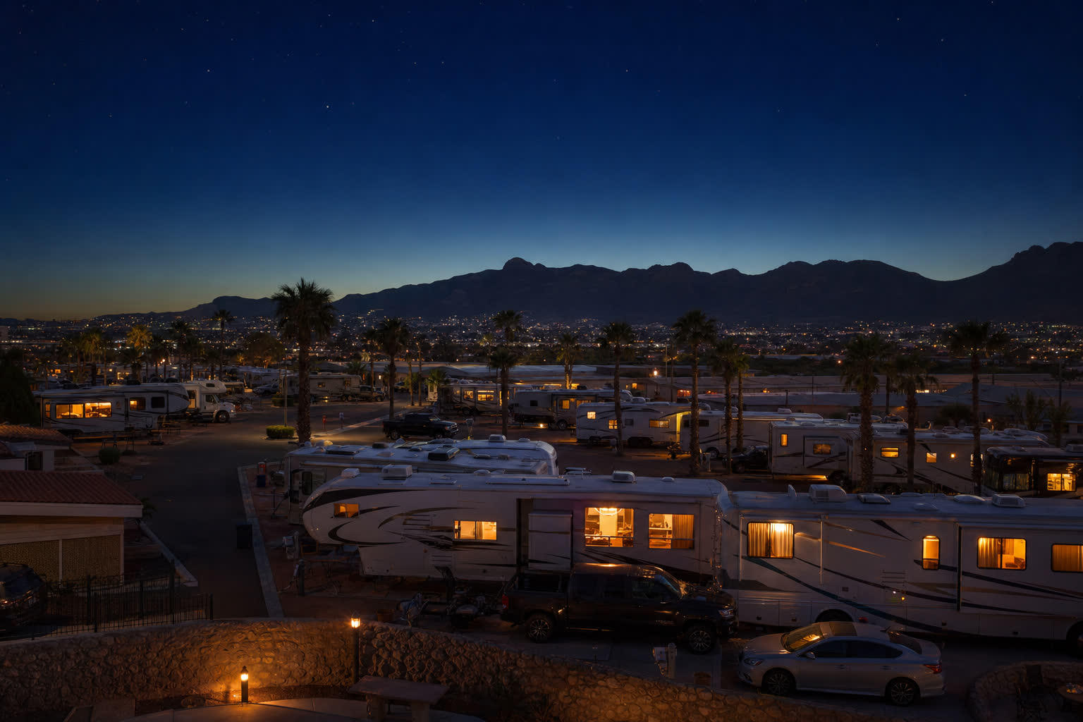 RV park at twilight with El Paso city lights and mountains in distance